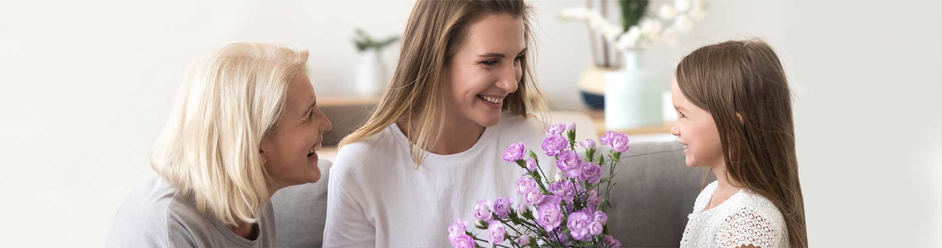 Mother holding flowers smiling at daughter